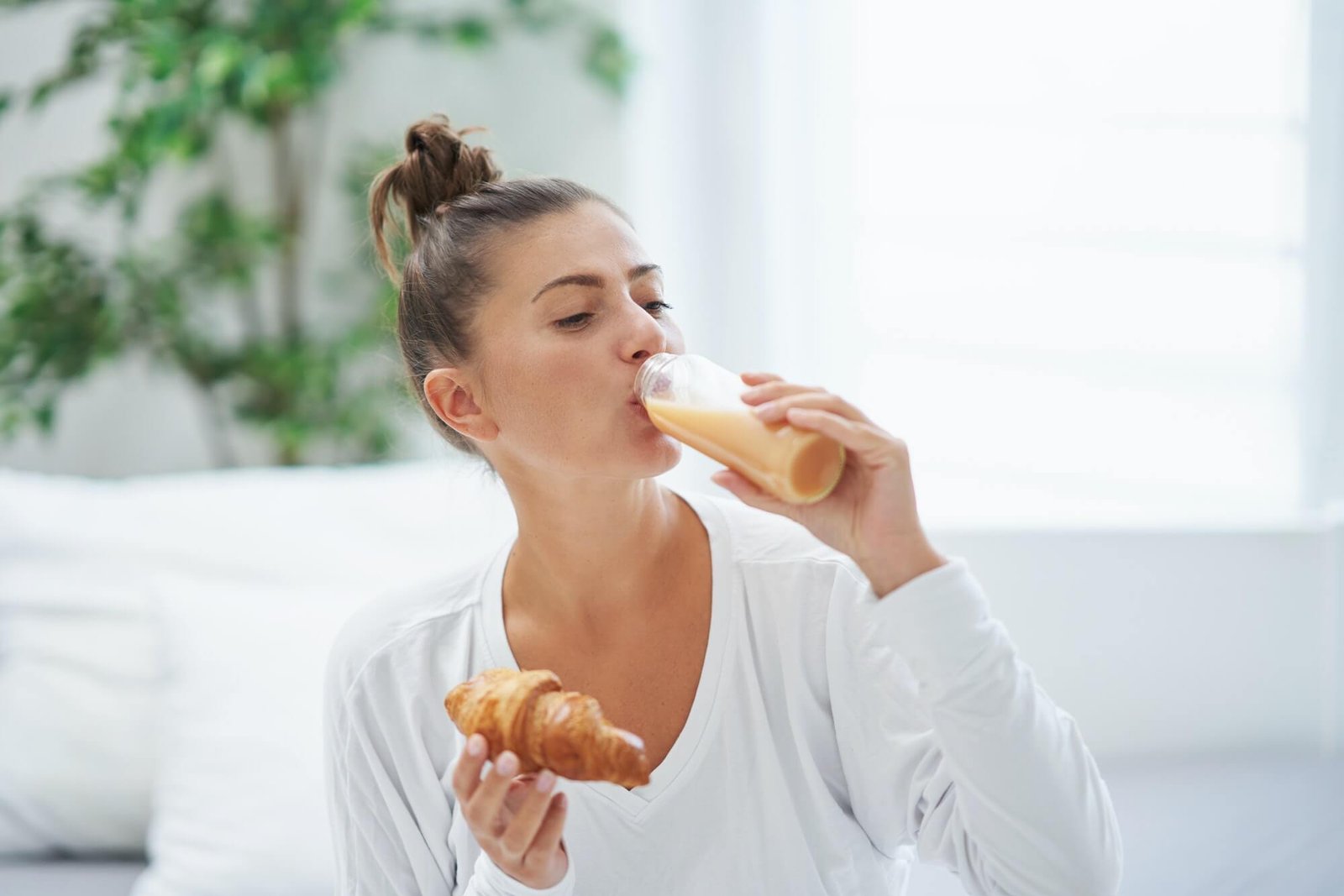 young-woman-on-bed-with-food-catering-box.jpg